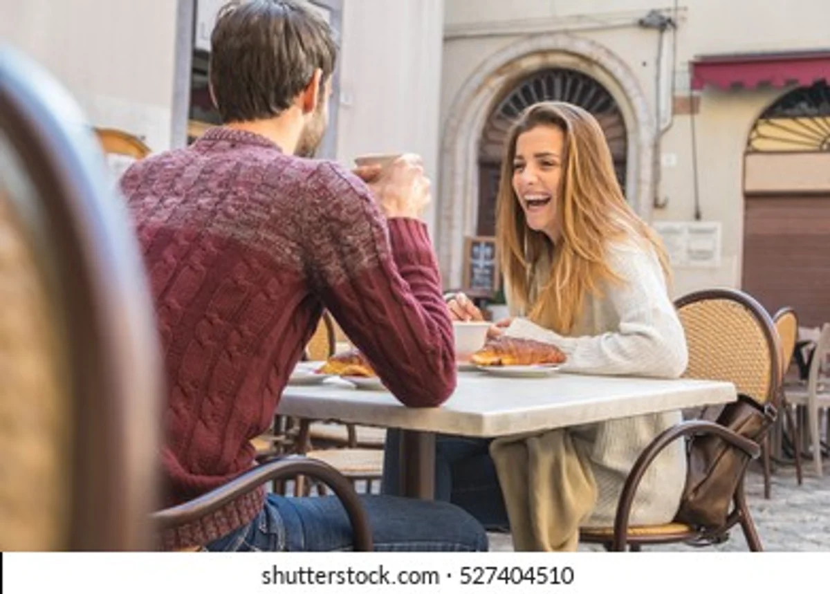 czech couple checking shopping app at cafe
