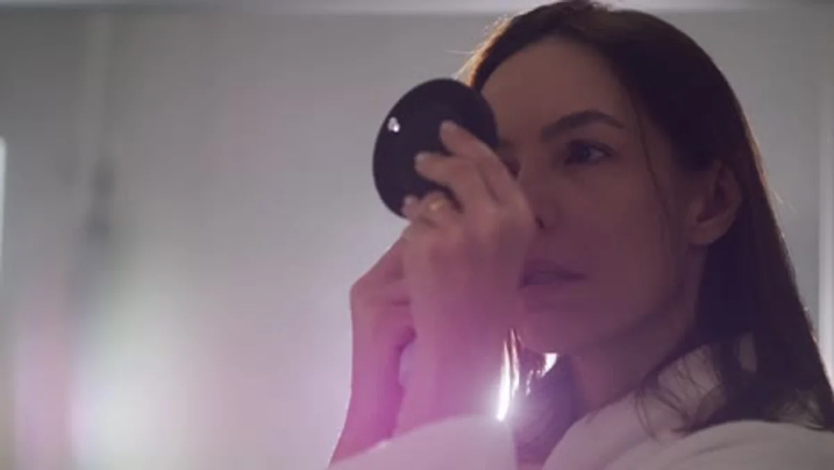 woman checking her skin morning mirror sleep analysis