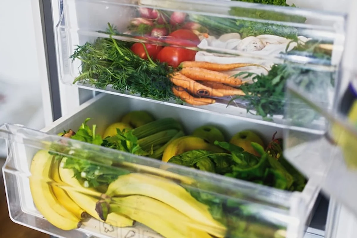 vegetables drawer in fridge with apples, carrots, broccoli, no plastic