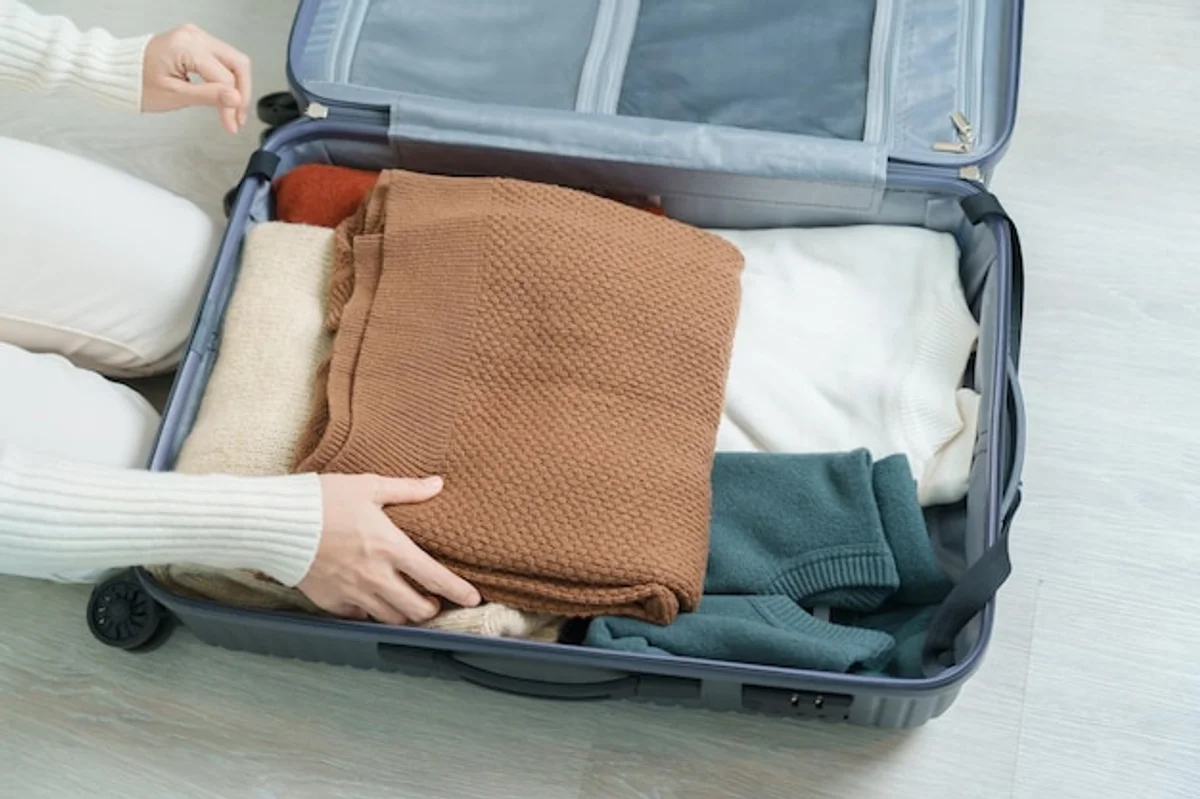 packing suitcase autumn travel minimalist