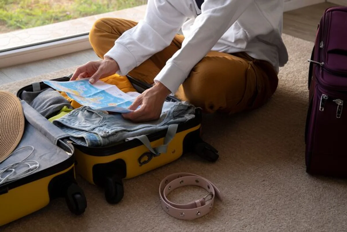 woman packing autumn clothes suitcase cozy hotel