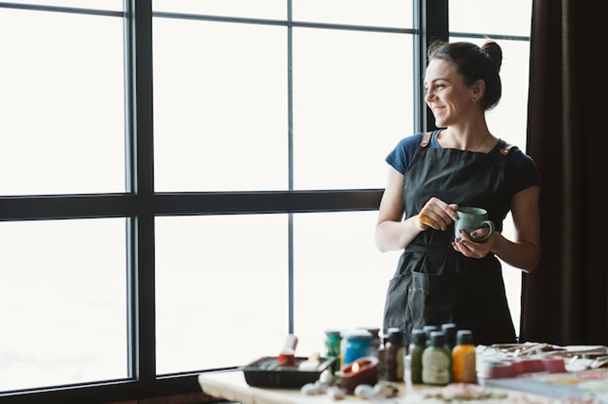 woman looking out window creative break inspiration