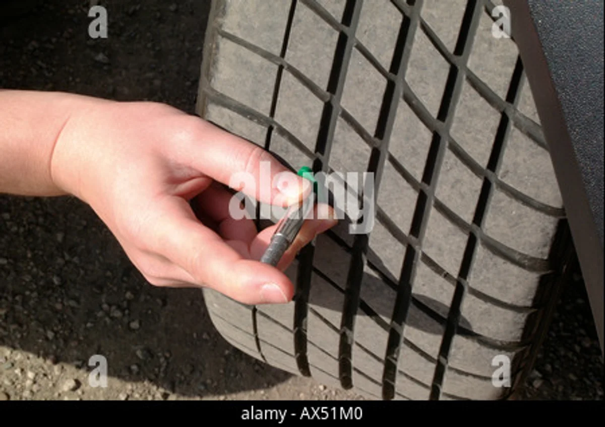 close-up checking tire tread depth autumn Czech car park