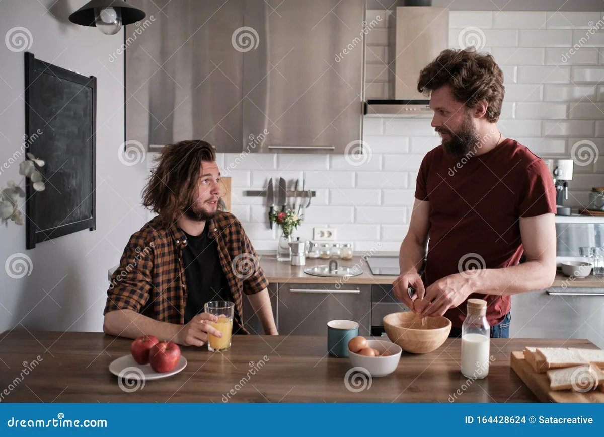 two czech friends talking calmly disagreement home kitchen