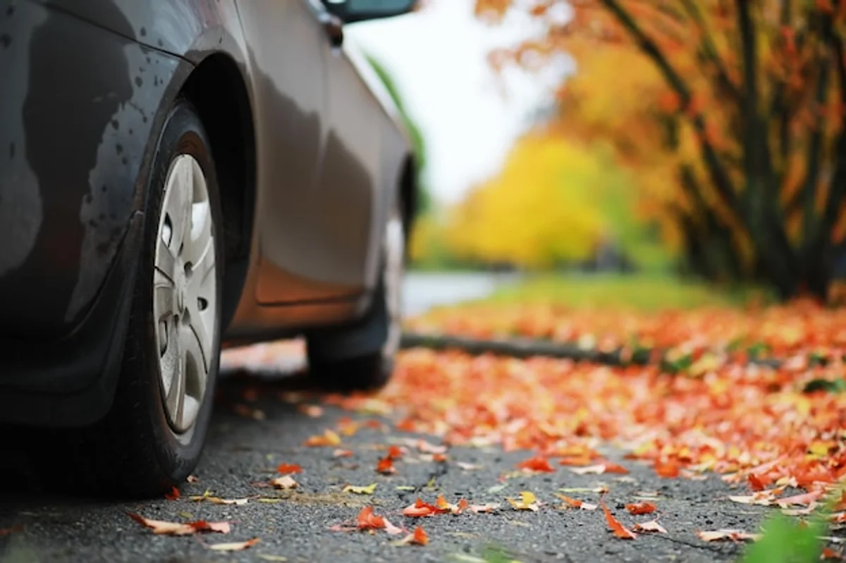 changing tires in autumn car road