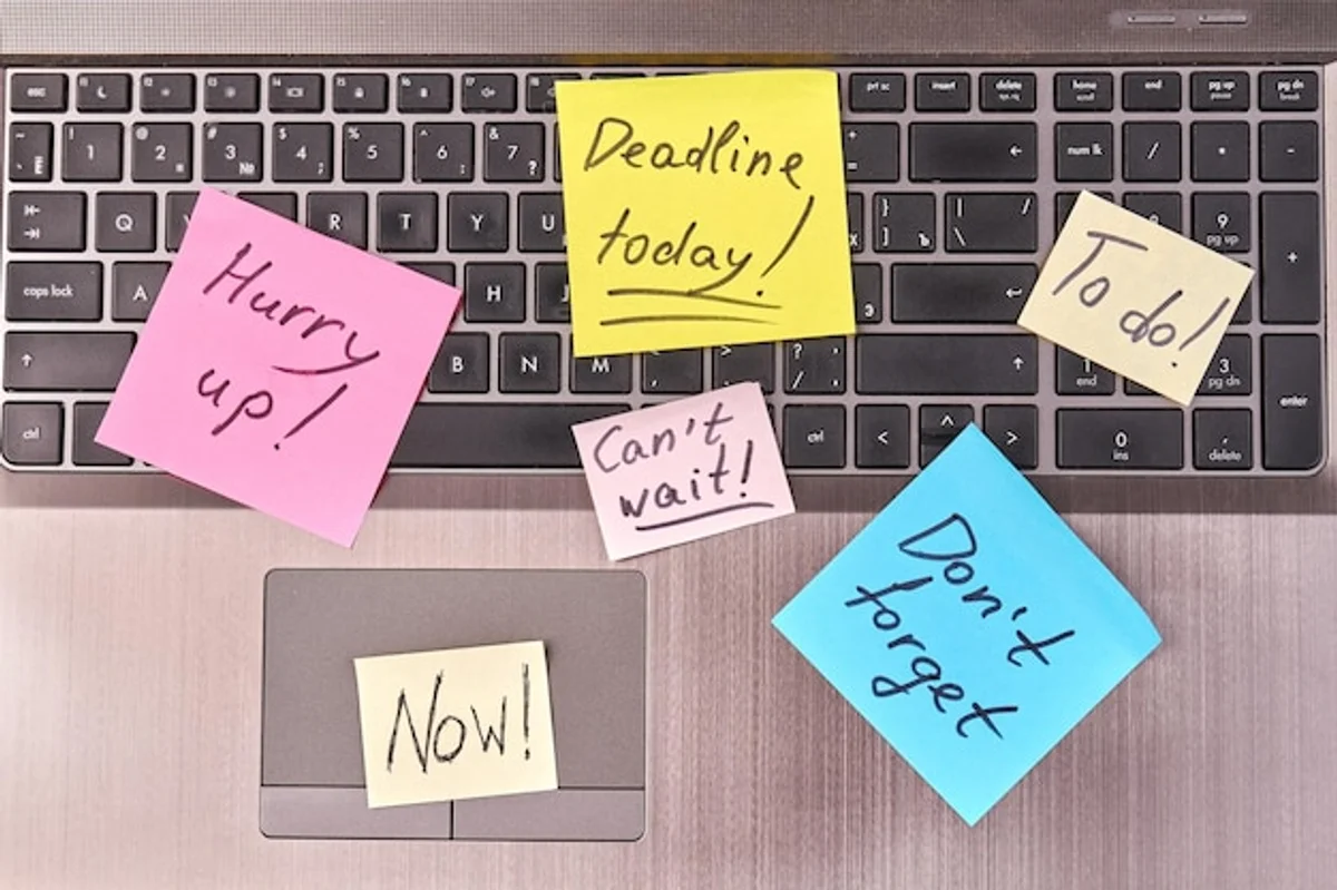 motivational sticky notes on laptop at home office