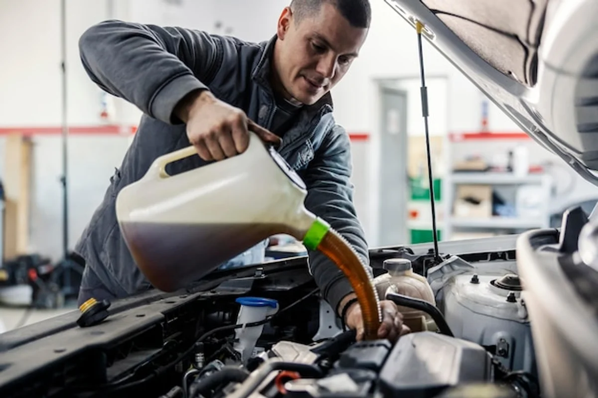 mechanic changing car oil modern garage