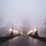 prague charles bridge november morning fog empty