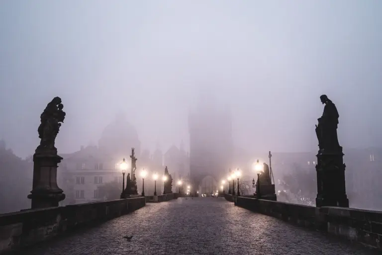 prague charles bridge november morning fog empty
