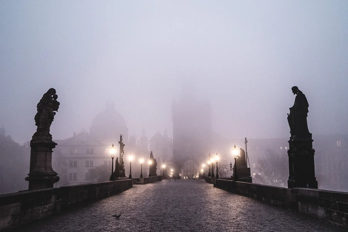 prague charles bridge november morning fog empty