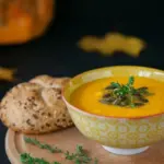 pumpkin soup with seeds and autumn vegetables close up