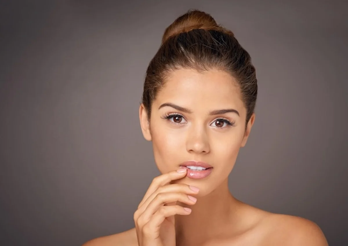 relaxed woman glowing skin natural background