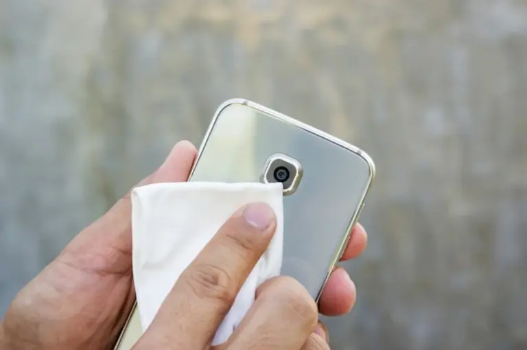 cleaning smartphone screen with steam and microfiber cloth