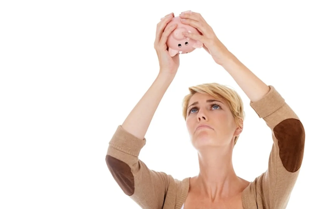 stressed person looking at empty piggy bank