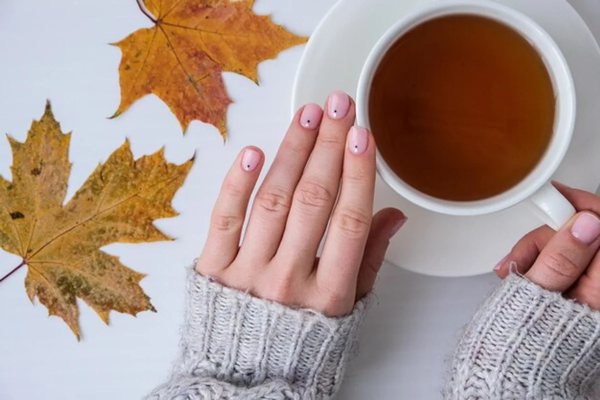 woman hand cream autumn leaves nails protection