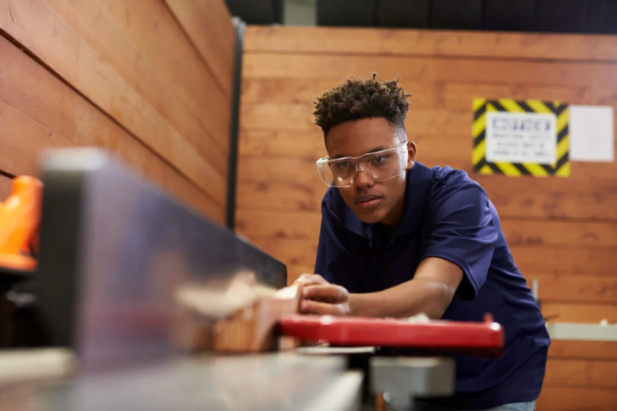 czech home workshop, woodworker with safety glasses, real life