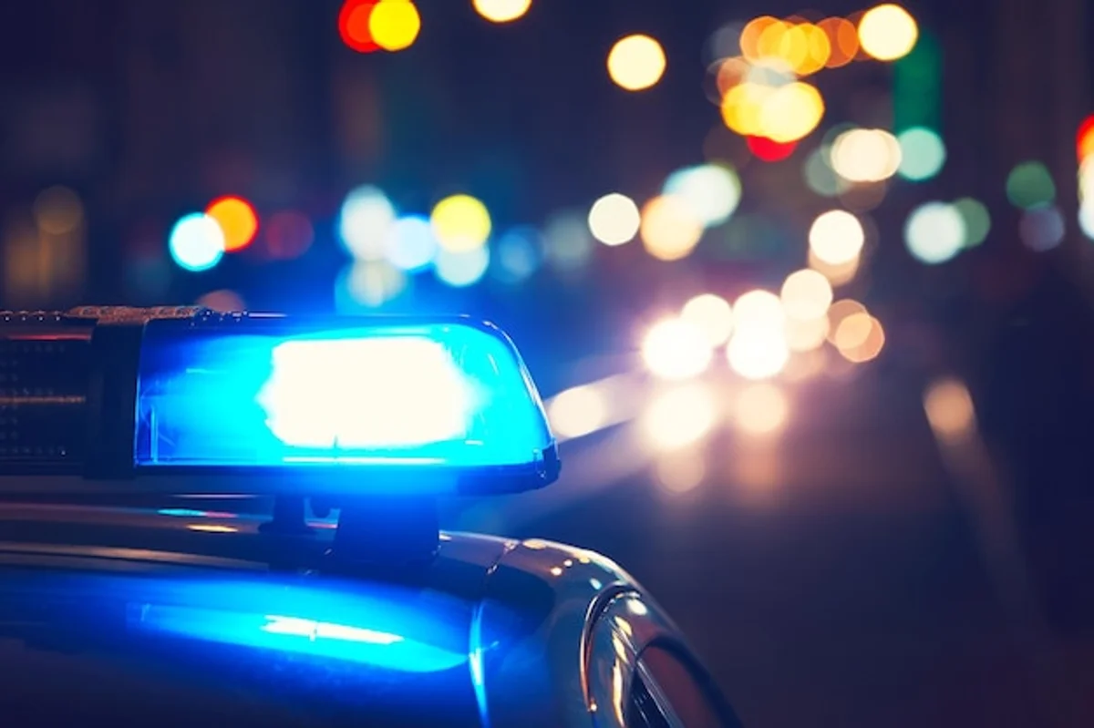 Czech driver adjusting car headlights at night